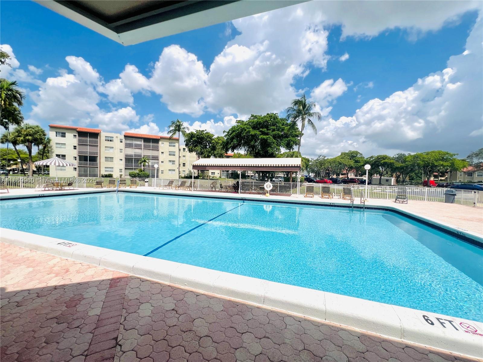 1810 Southwest 81st Avenue, Unit 2201 North Lauderdale, FL 33068 - Photo 22 of 32 a view of a swimming pool with outdoor seating