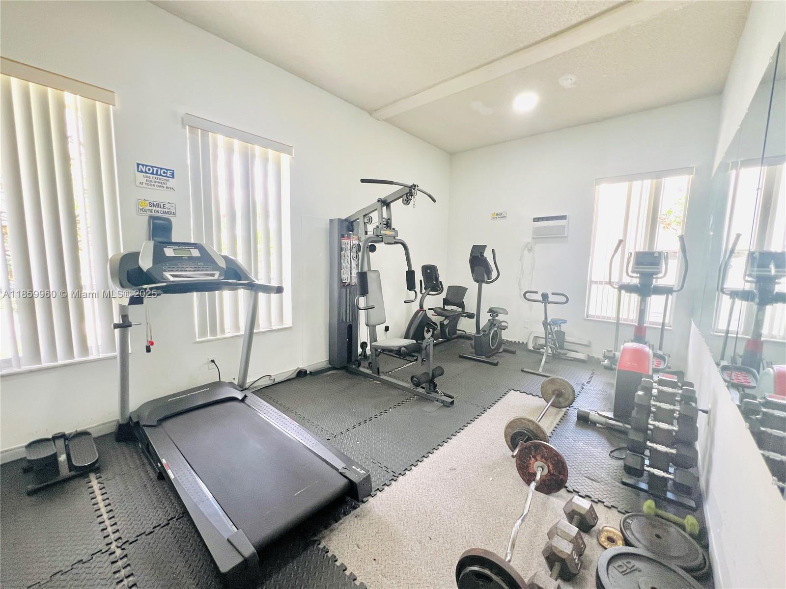 1810 Southwest 81st Avenue, Unit 2201 North Lauderdale, FL 33068 - Photo 25 of 32 a room with gym equipment and a large window