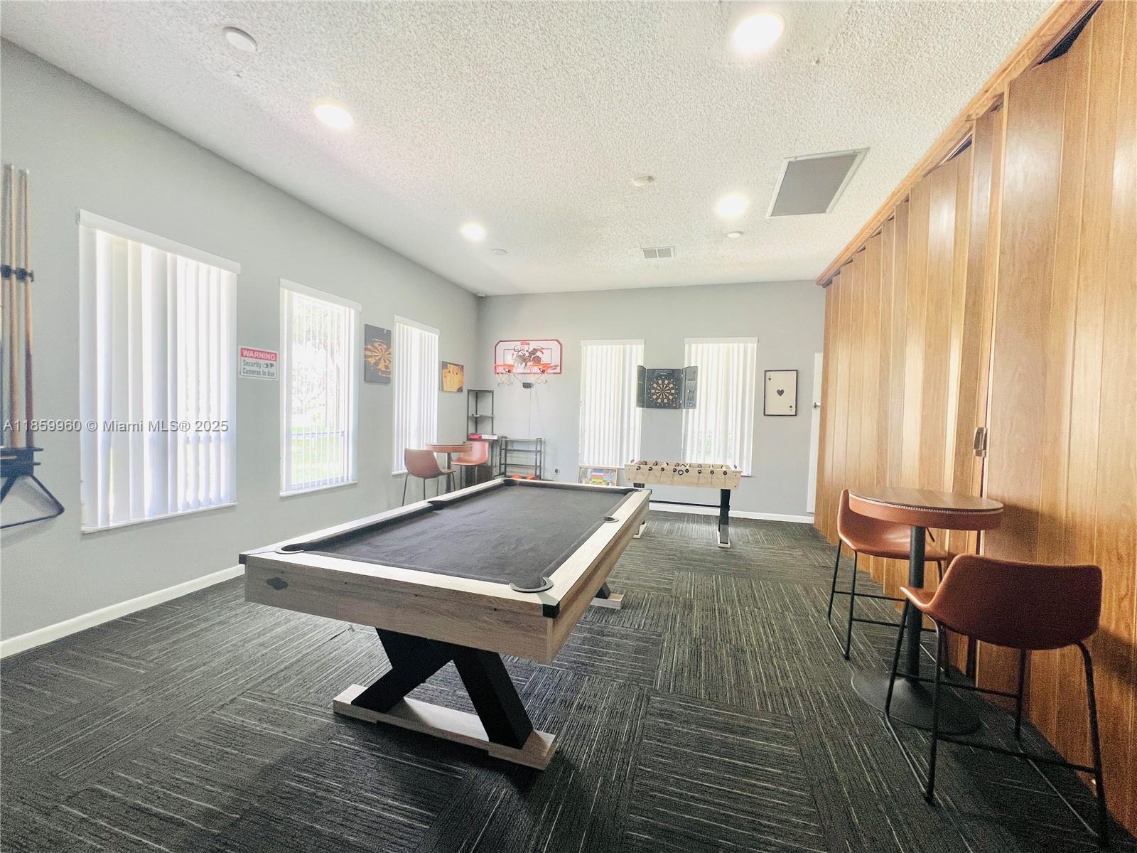 1810 Southwest 81st Avenue, Unit 2201 North Lauderdale, FL 33068 - Photo 28 of 32 a living room with furniture pool table and a large window