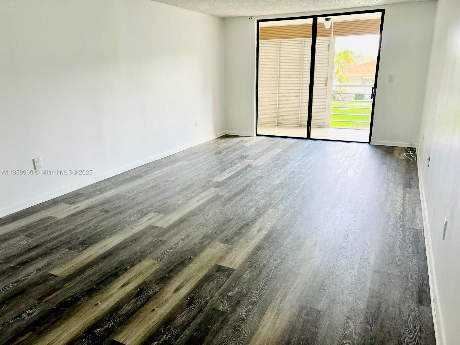 1810 Southwest 81st Avenue, Unit 2201 North Lauderdale, FL 33068 - Photo 5 of 32 a view of an empty room and wooden floor