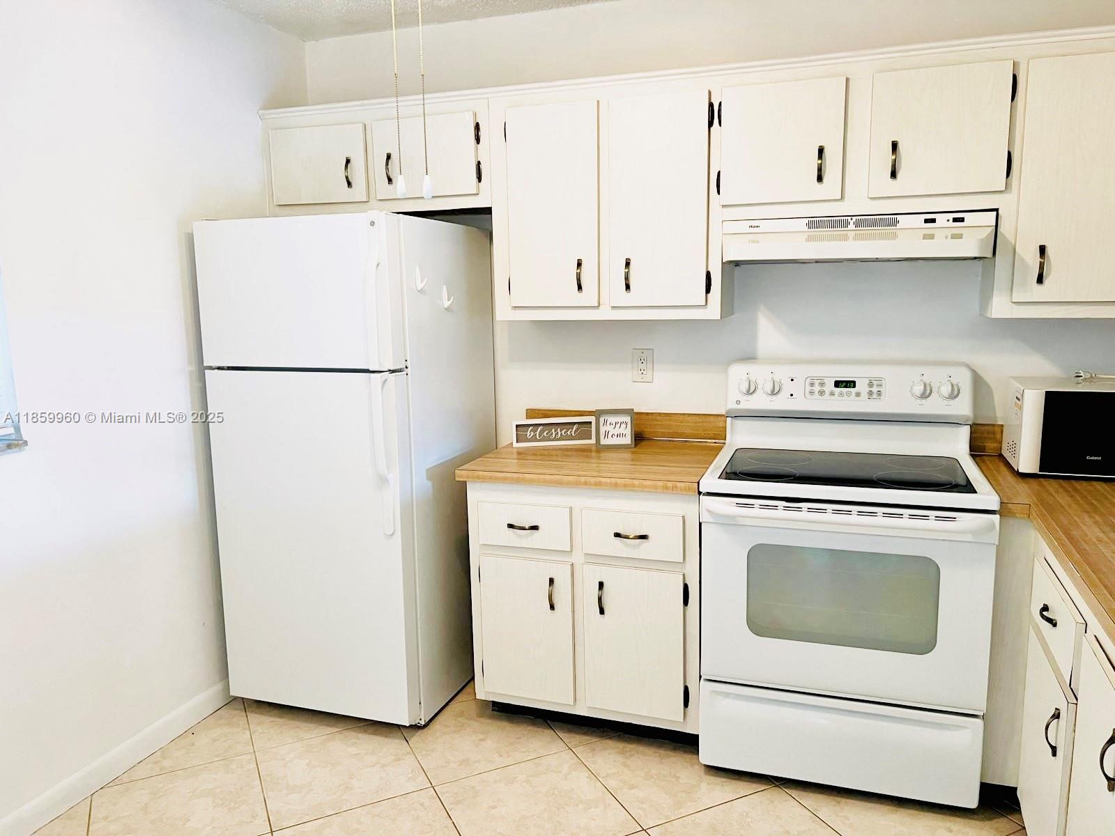1810 Southwest 81st Avenue, Unit 2201 North Lauderdale, FL 33068 - Photo 7 of 32 a white refrigerator freezer sitting in a kitchen