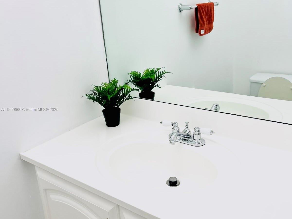 1810 Southwest 81st Avenue, Unit 2201 North Lauderdale, FL 33068 - Photo 8 of 32 a white vase with flowers on a shelf