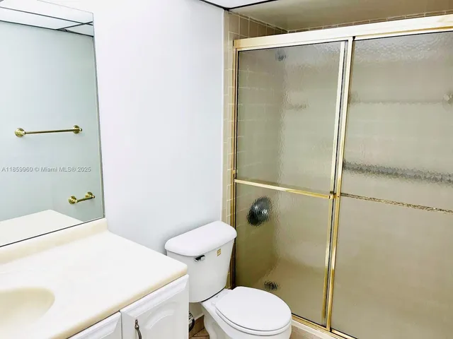 a white toilet sitting next to a bathroom sink