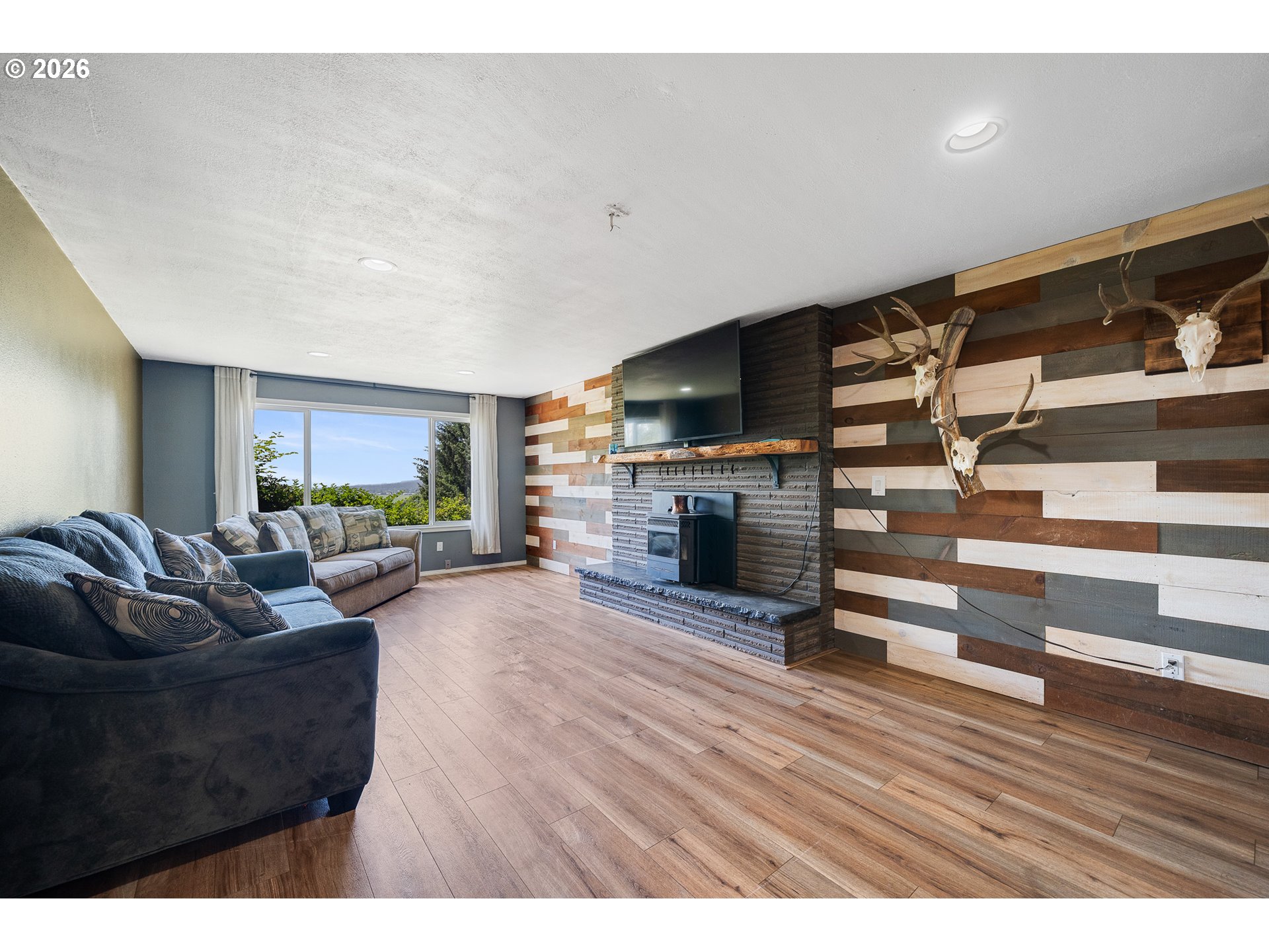 850 Hodgdon Road Tillamook, OR 97141 - Photo 5 of 43 a living room with furniture and a fireplace