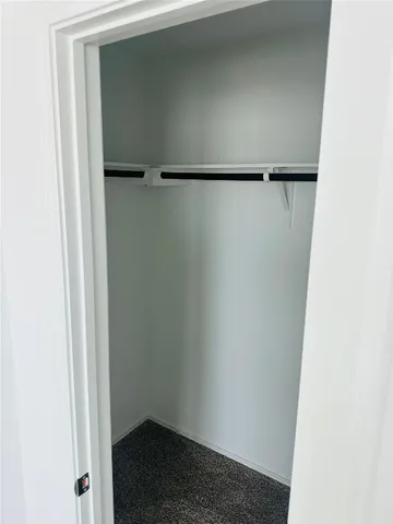 a view of walk in closet with clothes