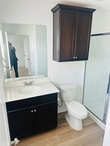 a bathroom with a sink a toilet a mirror and vanity