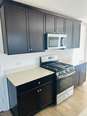 a kitchen with a stove and a microwave