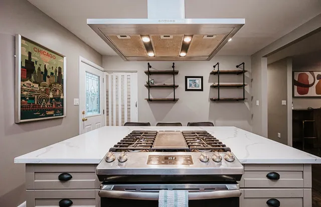 a stove top oven sitting inside of a kitchen