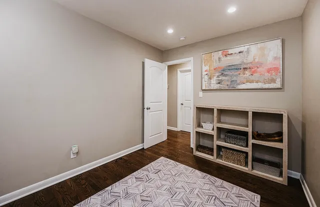 a view of a hallway with furniture