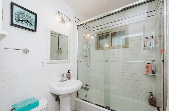 a bathroom with a sink a mirror and a shower