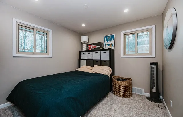 a bedroom with a bed and a window