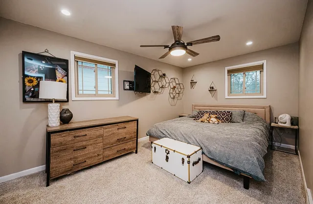 a bedroom with a bed and a chandelier