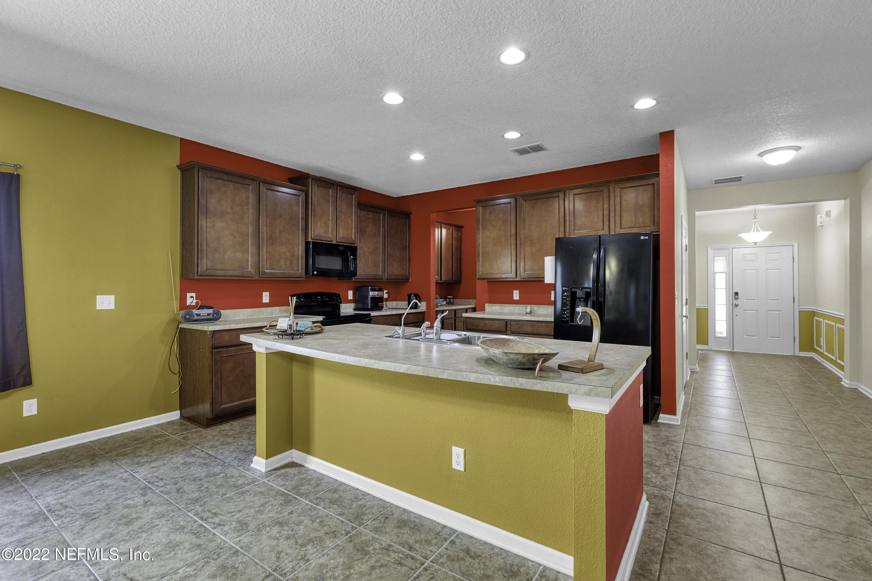 300 Auburn Oaks Road East Jacksonville, FL 32218 - Photo 5 of 15 a kitchen with stainless steel appliances granite countertop a stove and a refrigerator