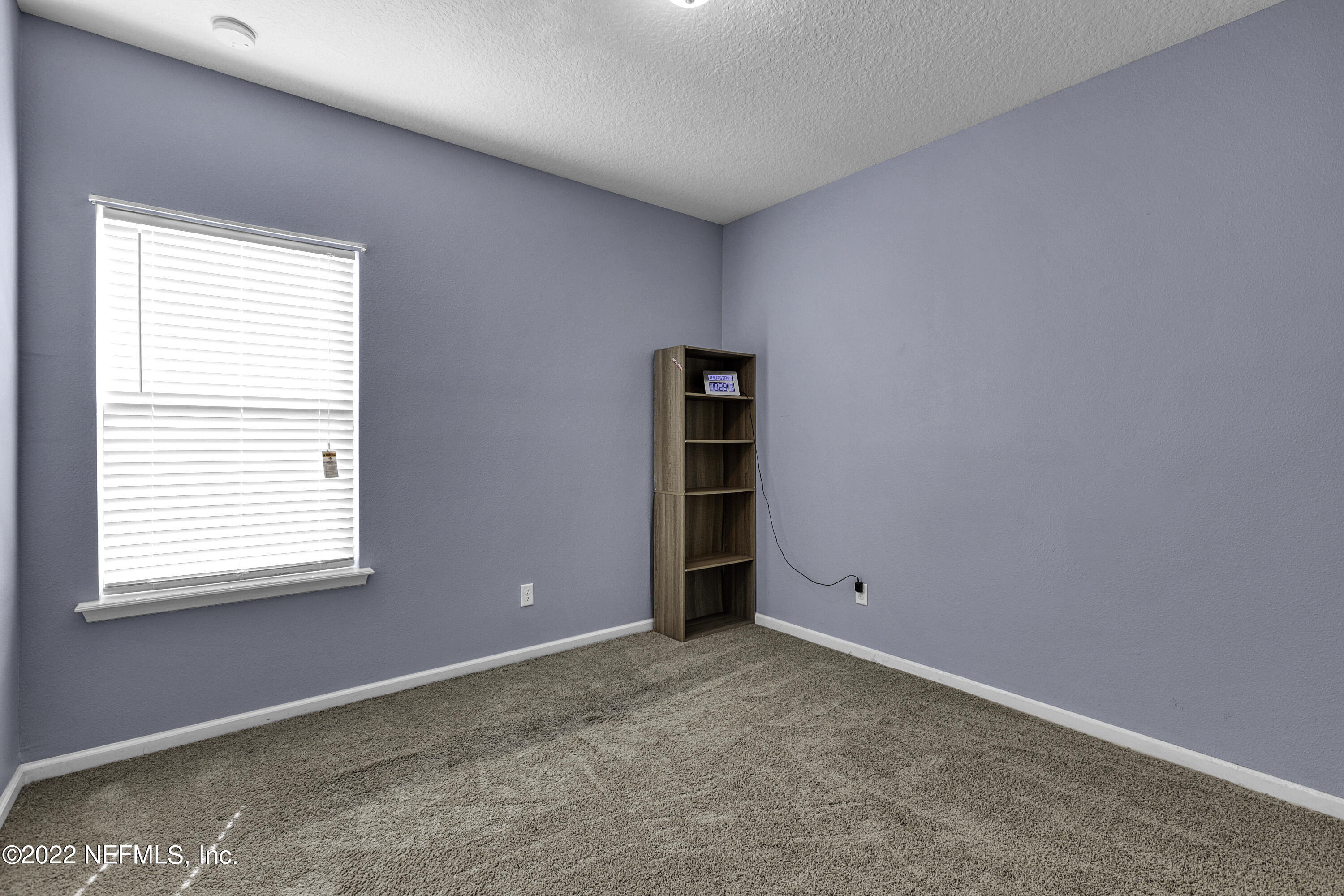 300 Auburn Oaks Road East Jacksonville, FL 32218 - Photo 6 of 15 an empty room with a window and cabinet
