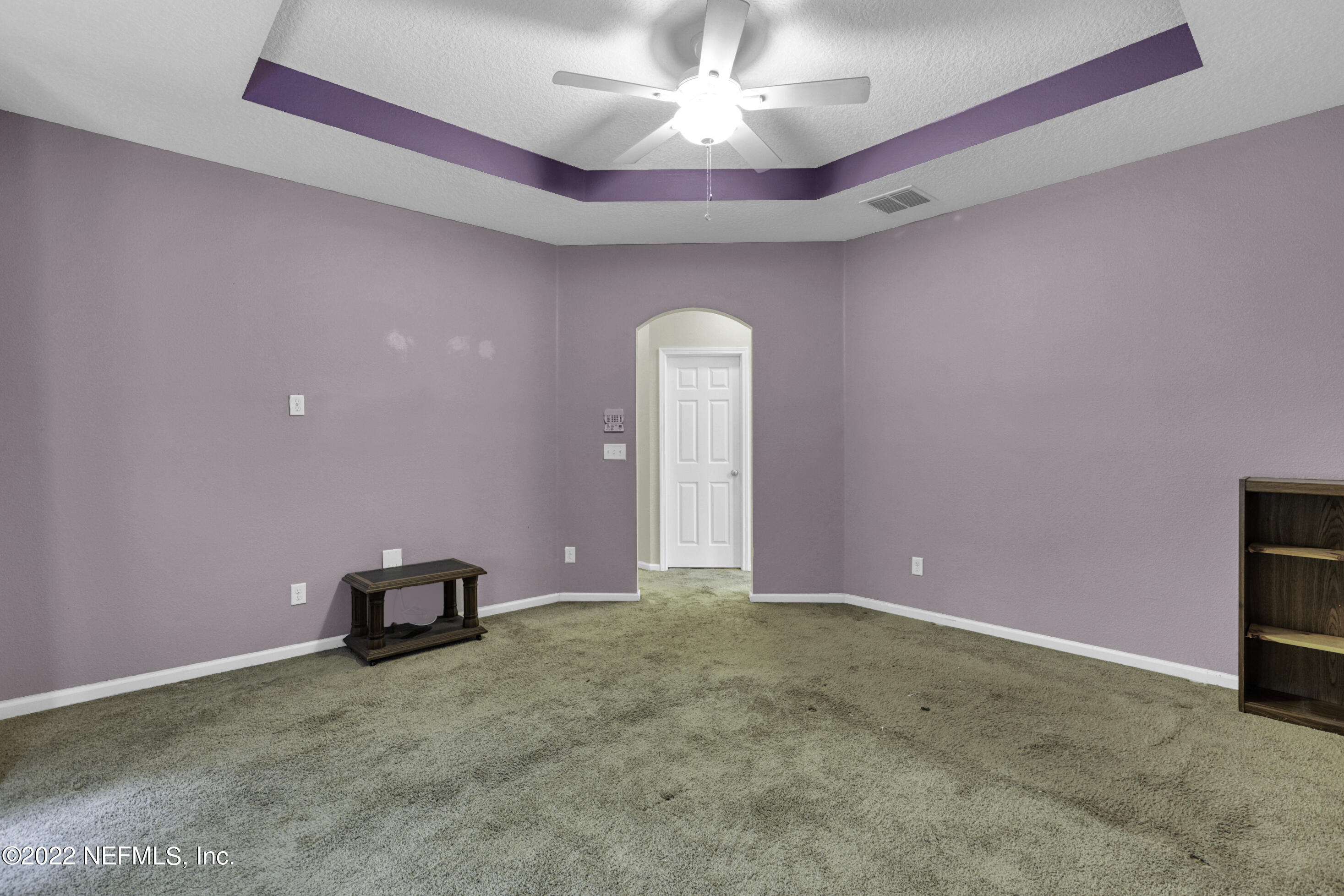 300 Auburn Oaks Road East Jacksonville, FL 32218 - Photo 8 of 15 a view of a livingroom with a chandelier fan and a bookshelf