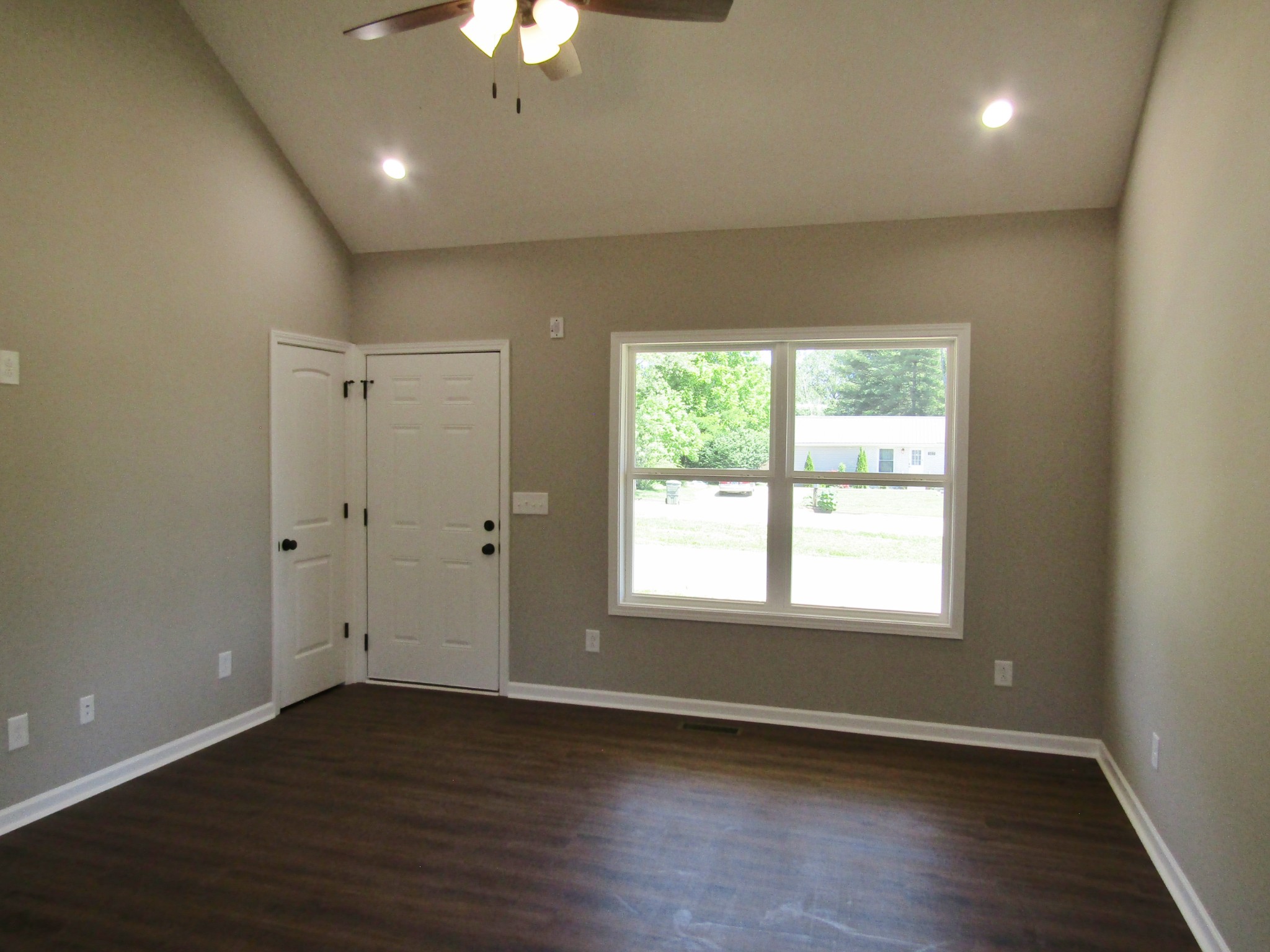 470 Crescent Factory Road Lawrenceburg, TN 38464 - Photo 4 of 15 an empty room with wooden floor and windows