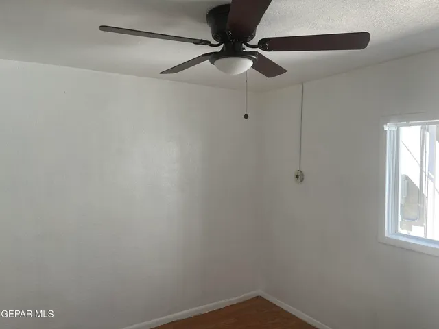 a view of a small space with a ceiling fan and a window