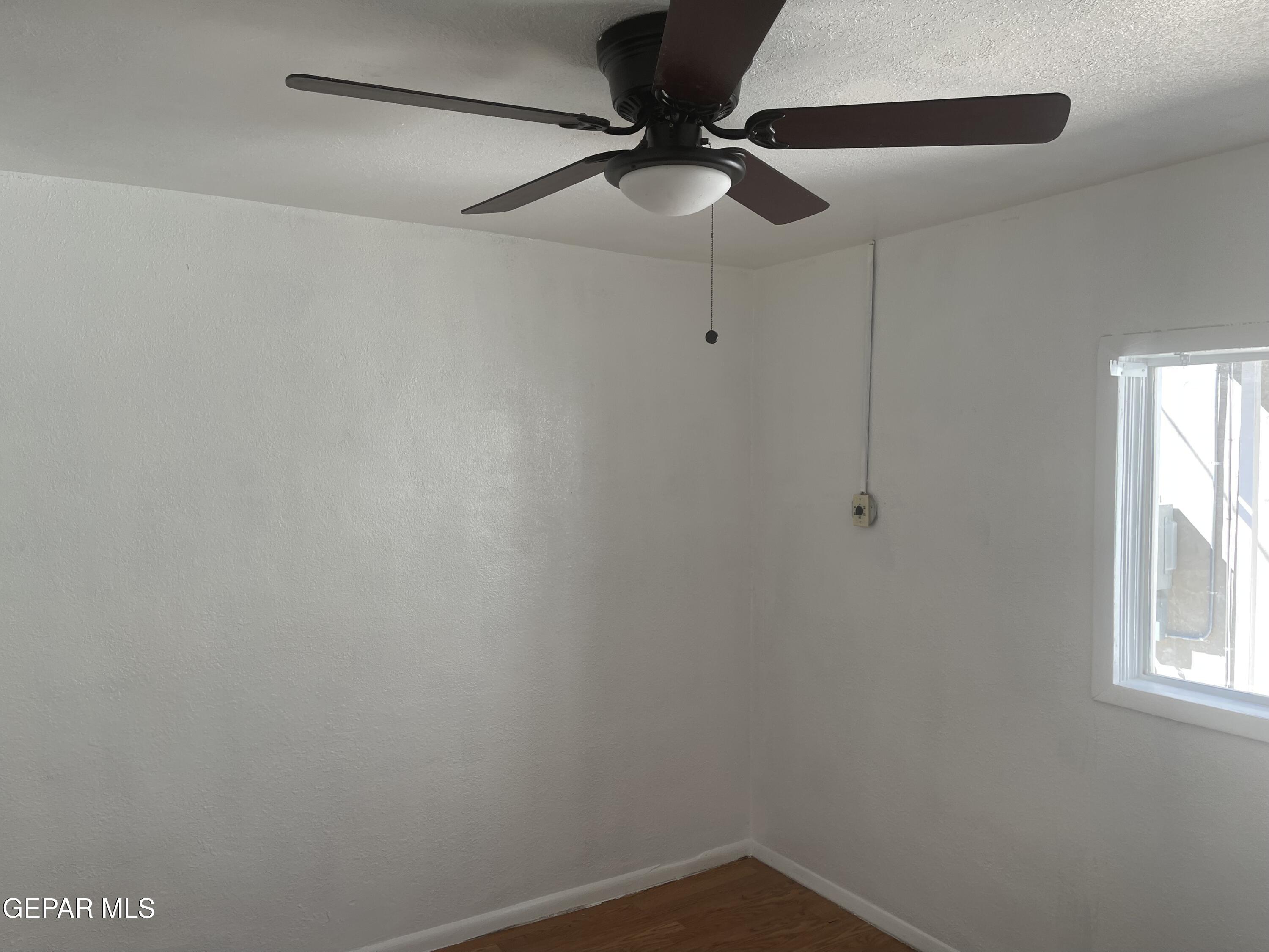 1026 Myrtle Avenue, Unit 6 El Paso, TX 79901 - Photo 6 of 7 a view of a small space with a ceiling fan and a window