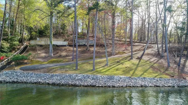 a view of swimming pool with a patio and a yard