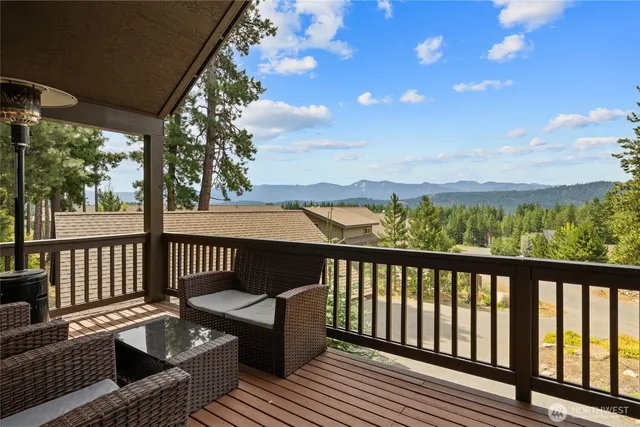 a view of balcony with wooden floor and seating space