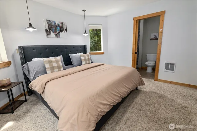 a bedroom with bed and window