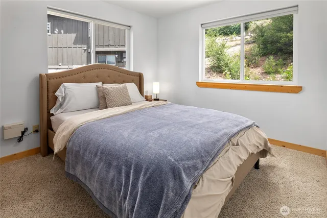 a bed sitting in a bedroom next to a window