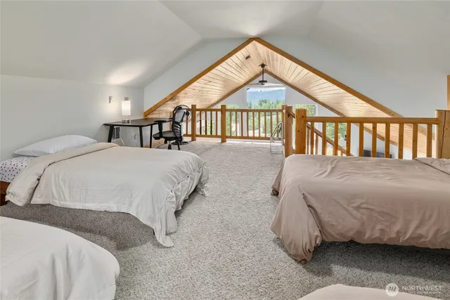 a bed sitting in a bedroom next to a window