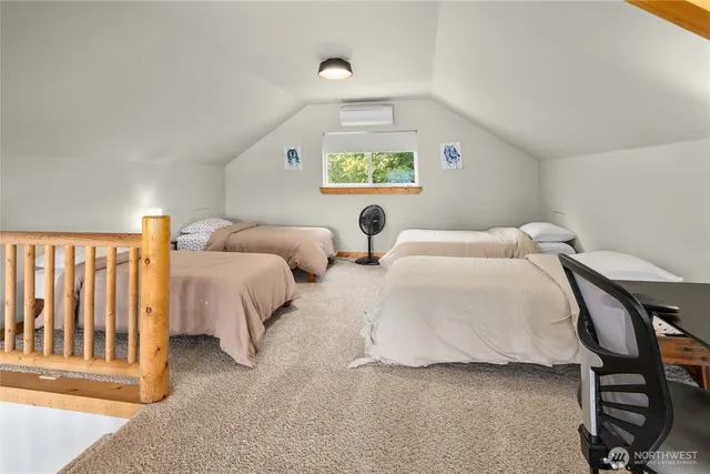 a bedroom with 2 bed and a window