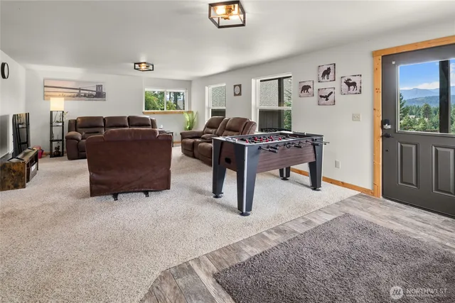 a living room with furniture window and a flat screen tv