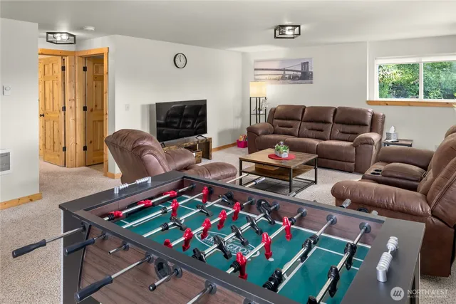 a living room with furniture a rug and a window