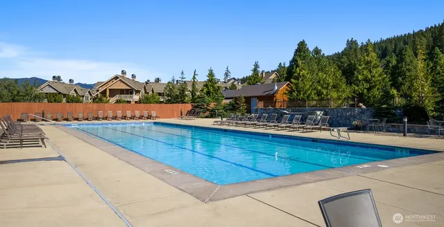 a view of swimming pool with outdoor seating and city view