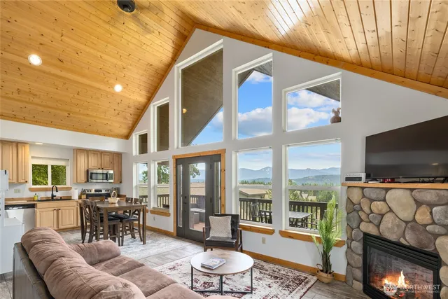 a living room with furniture a flat screen tv and a large window