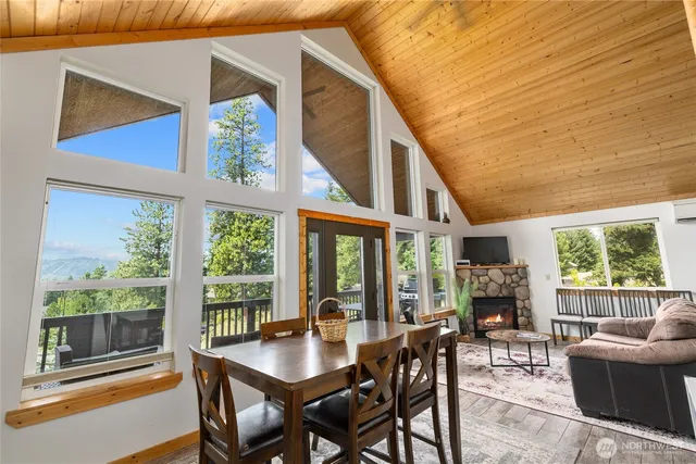 a dining room with furniture a rug and a large window
