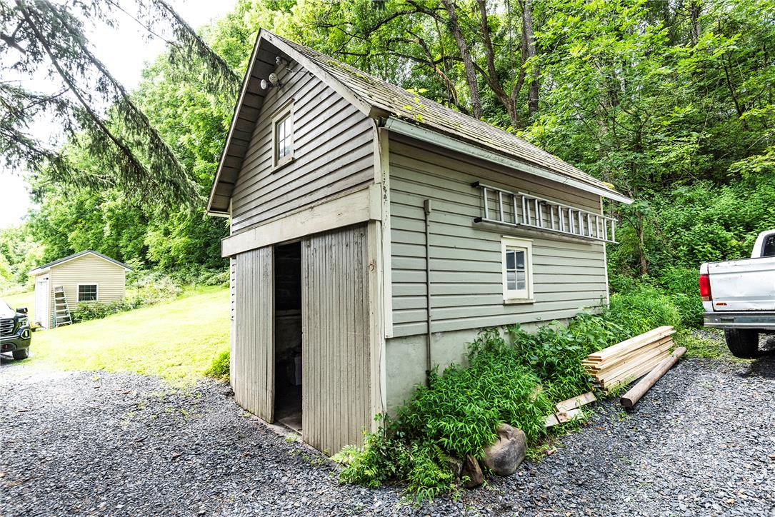 100 Creek Road Bangor, PA 18013 - Photo 20 of 51 A well-maintained outbuilding offers additional storage or potential for a creative workshop amid verdant surroundings.