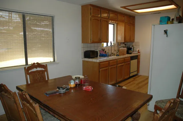 a kitchen with refrigerator a sink and cabinets
