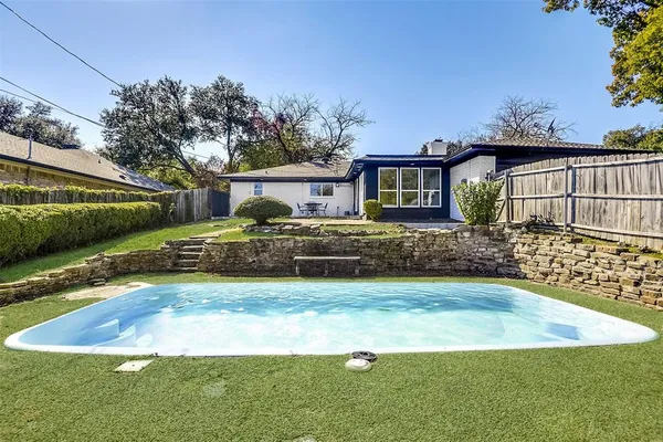 a view of a swimming pool with a patio