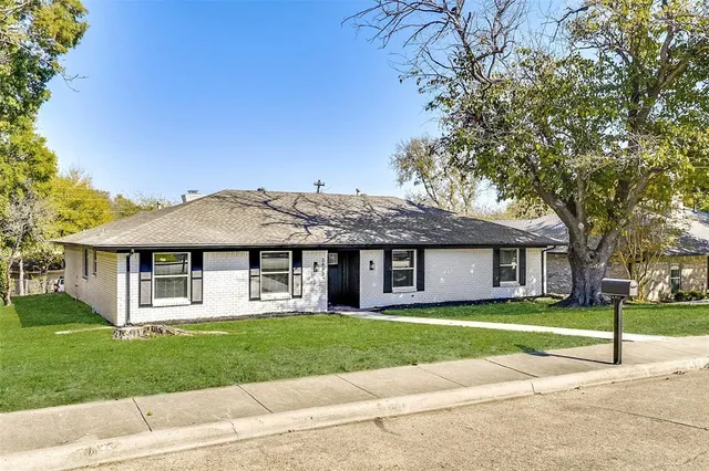 a house view with a sitting space and garden