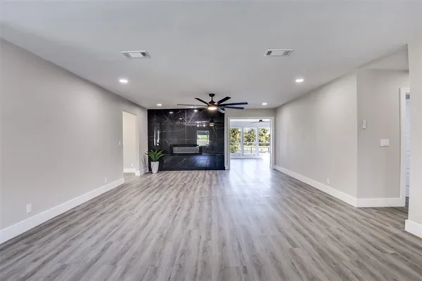 a view of a hallway with wooden floor