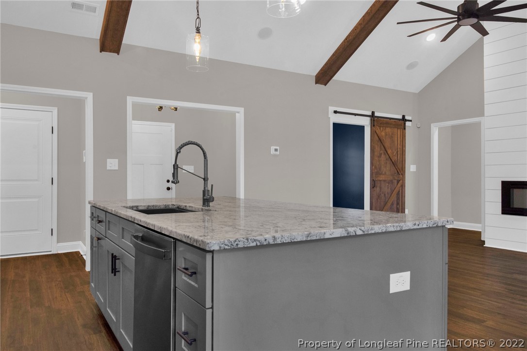 171 Mumford Road Raeford, NC 28376 - Photo 13 of 35 a kitchen with stainless steel appliances granite countertop a sink a stove top oven a counter space and cabinets