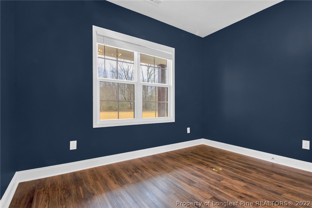 171 Mumford Road Raeford, NC 28376 - Photo 16 of 35 a view of an empty room with wooden floor and a window