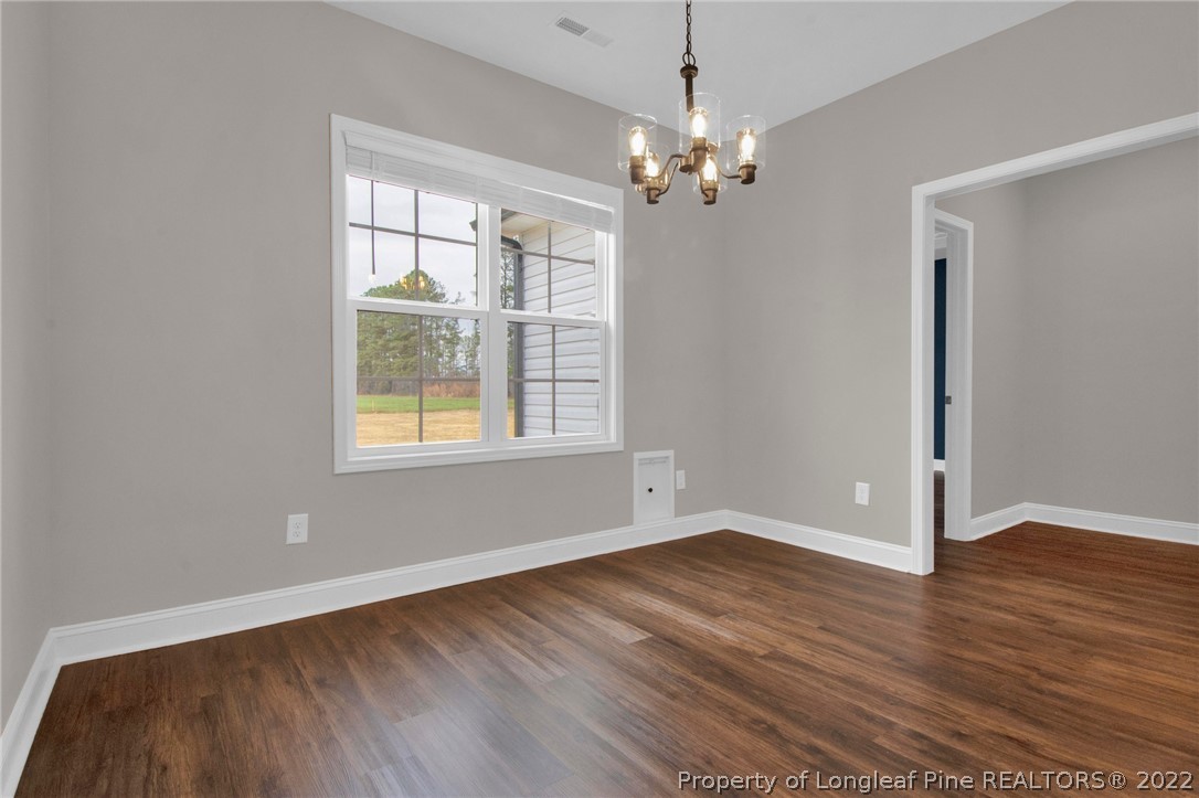 171 Mumford Road Raeford, NC 28376 - Photo 24 of 35 a view of an empty room with wooden floor and a window