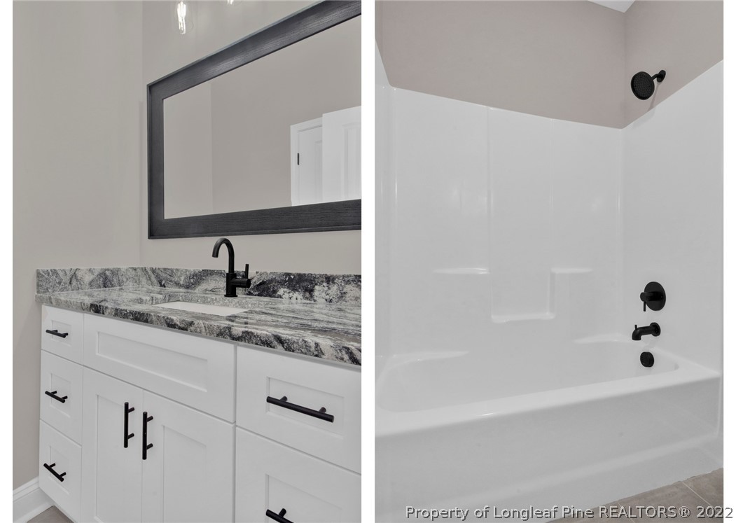 171 Mumford Road Raeford, NC 28376 - Photo 29 of 35 a bathroom with a tub sink and mirror
