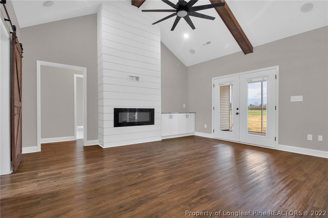 171 Mumford Road Raeford, NC 28376 - Photo 5 of 35 a view of an empty room with a window and wooden floor