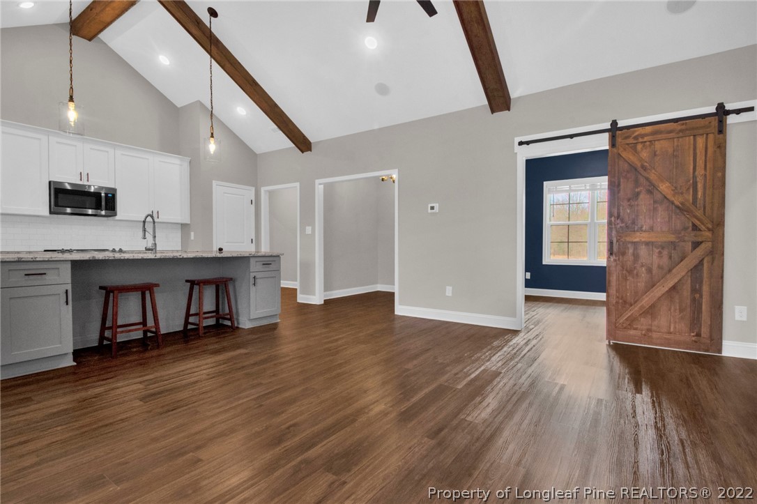 171 Mumford Road Raeford, NC 28376 - Photo 8 of 35 a living room with kitchen island granite countertop wooden floor and a refrigerator