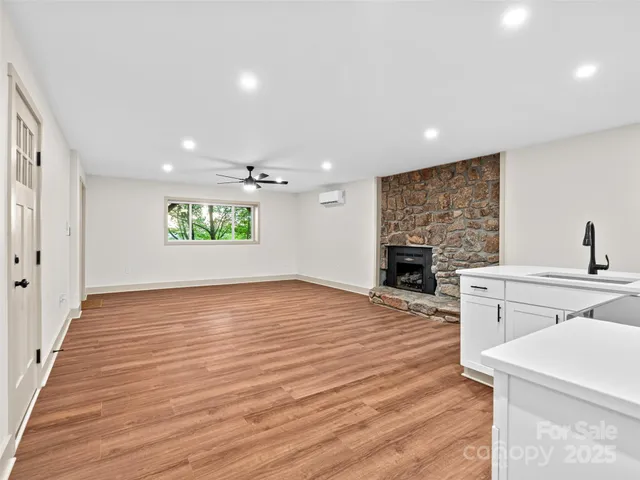 a view of a big room with wooden floor closet and windows