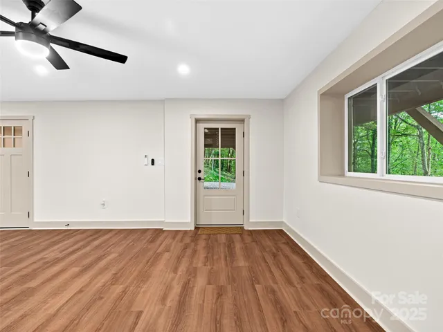 a view of empty room with wooden floor