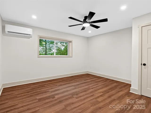 a bathroom with a granite countertop sink toilet a shower and a mirror