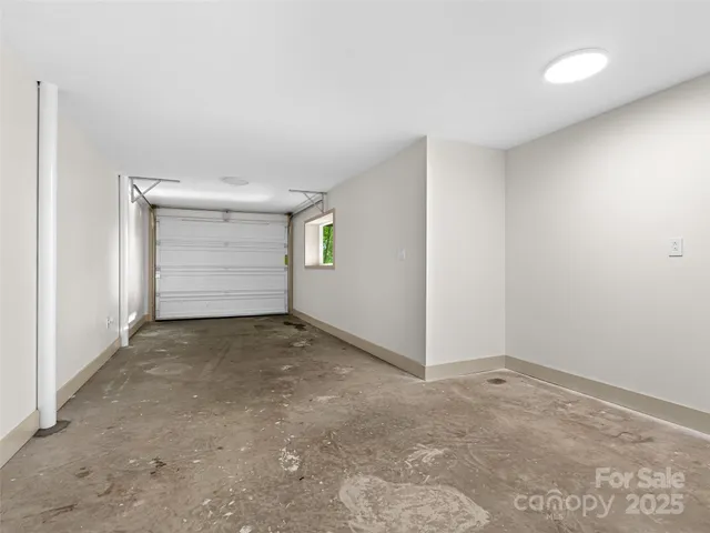 an aerial view of a house with porch and wooden fence