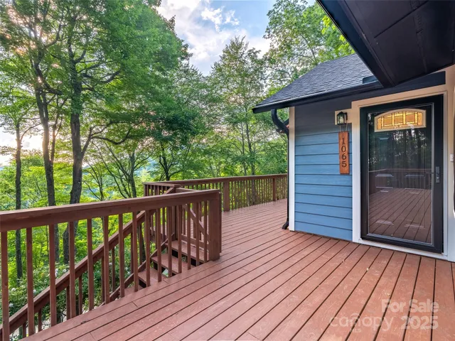 a balcony with wooden floor and fence