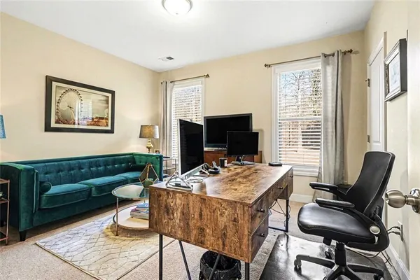 a view of a livingroom with furniture and a flat screen tv